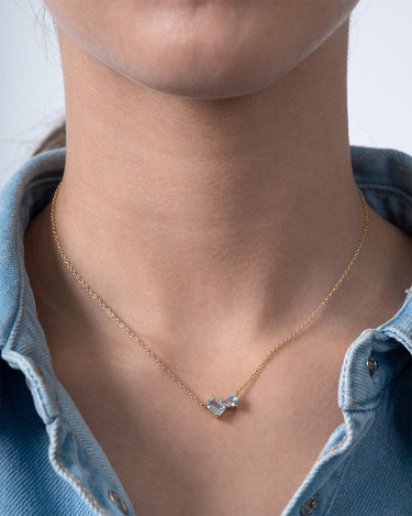 Colgante Bow topacio azul, plata dorada
